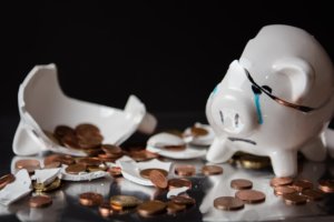 broken piggy bank with coins scattered