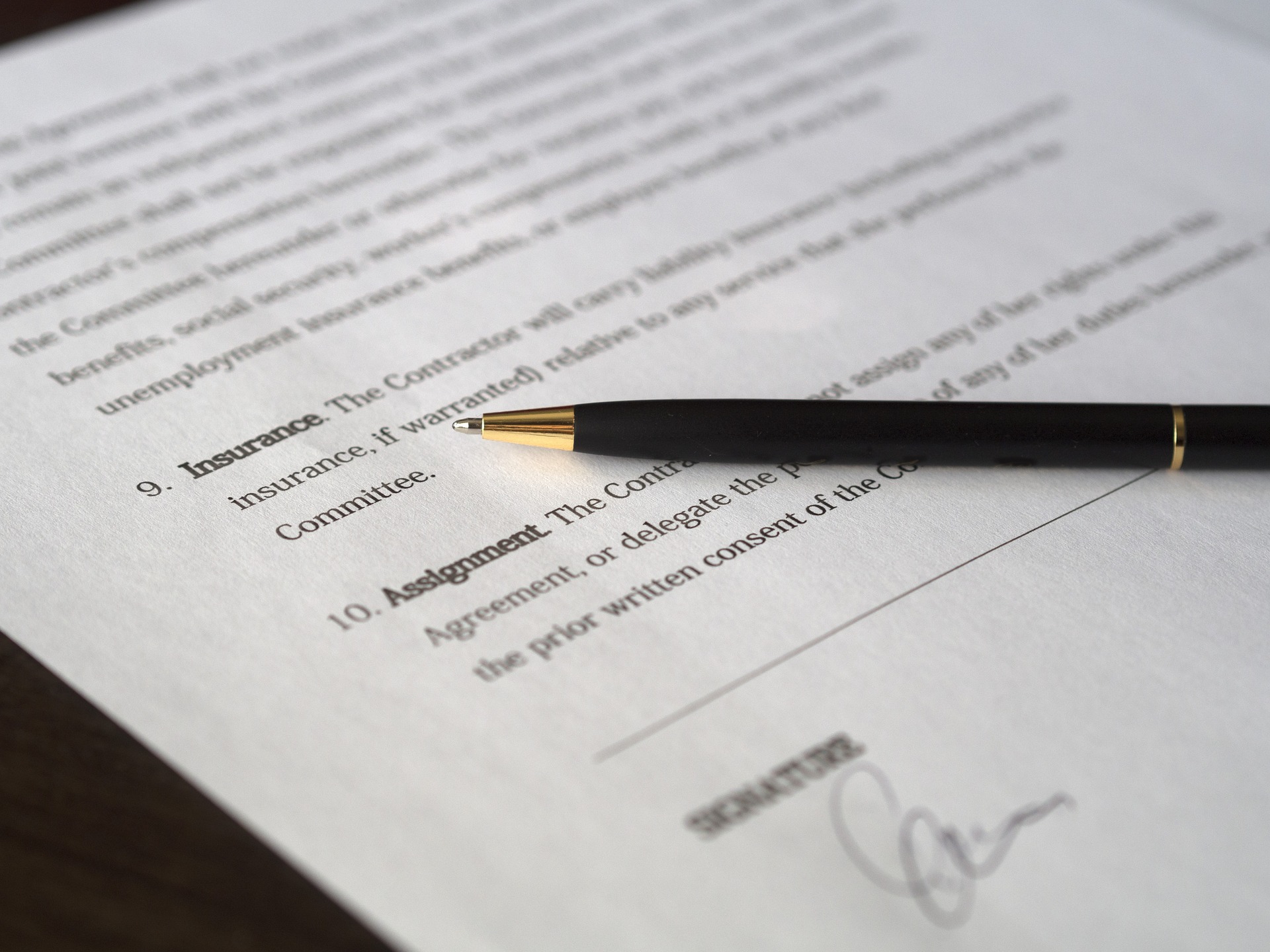 A signed contract showing an insurance clause