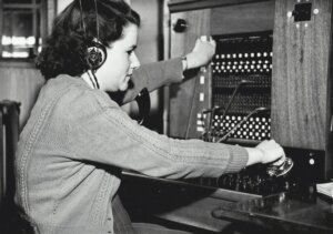black and white photo of a woman at a switchboard