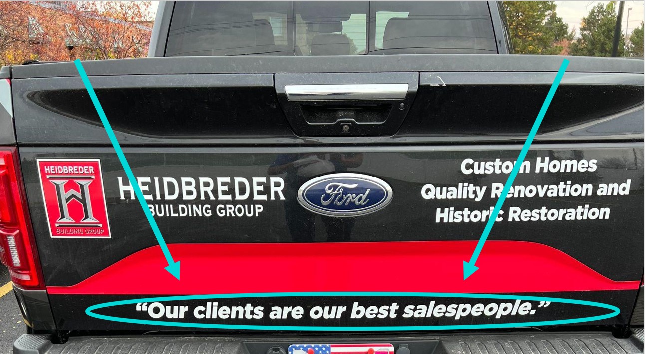 The back of a pickup truck with a sign saying "Our clients are our best salespeople."