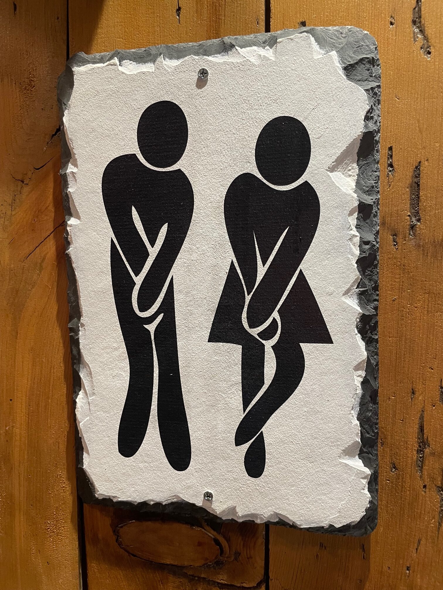 Male and female figures looking like they have to go to the bathroom. 