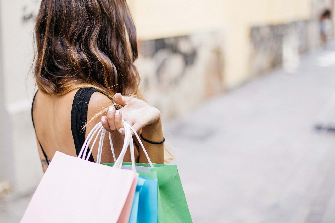 A woman carries several shopping bags over her shoulder. Clienteling is a retail strategy that better connects retailers and shoppers with a personalized experience.