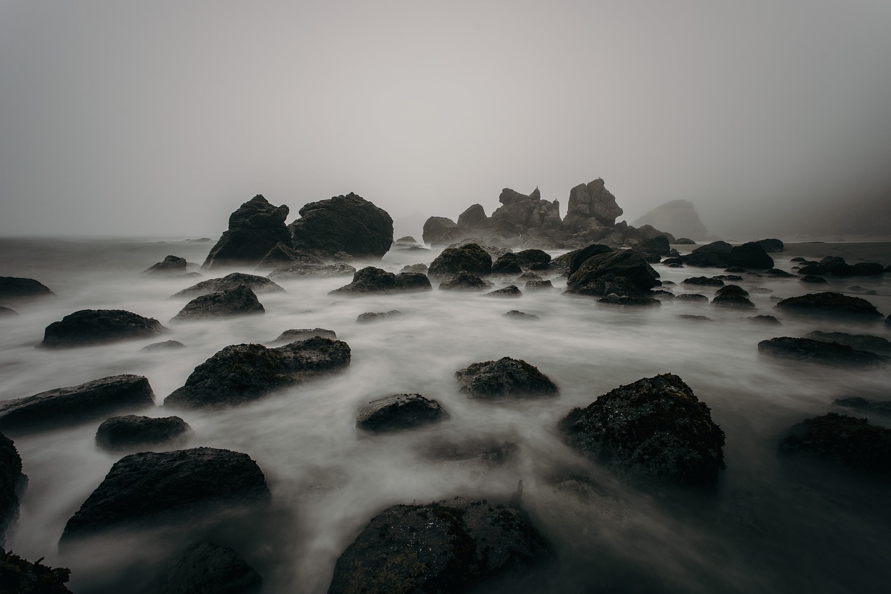 Large rocks are scattered in a body of water in this foggy image. Reducing effort for customers is like removing big rocks in their way.