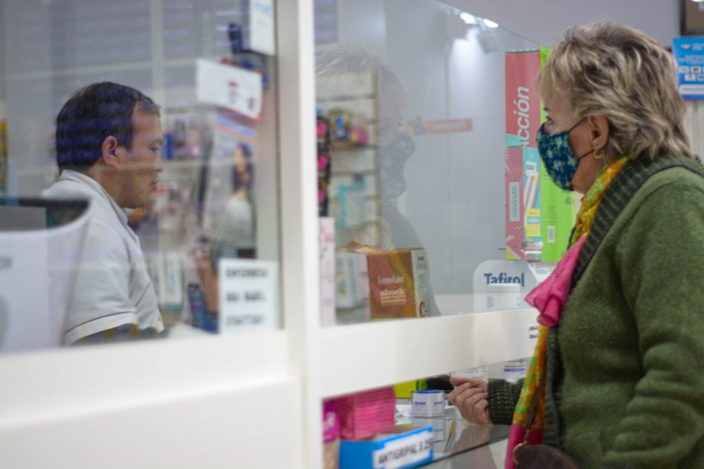 customer on the counter waiting for her prescription meds to be dispensed